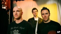FILE - Band members from The Script, Mark Sheehan, left, Danny O'Donoghue, center, and Glen Power pose for a portrait, May 29, 2009 in New York.