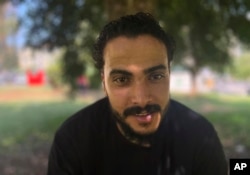 Ali Elwan of Egypt, who survived the sinking of a ship 1 year ago, poses for a photo after an interview with The Associated Press in Athens, June 7, 2024.