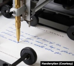 A robotic arm created by the Handwrytten company writes a "personalized" letter for a business that wants to foster better communication with its customers. (Courtesy photo)