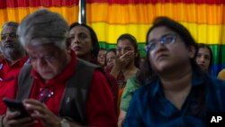 In Mumbai, India, supporters and members of the LGBTQ community react as they watch a screen showing the Supreme Court's rejection of the legalization of same-sex marriage on Oct. 17, 2023.