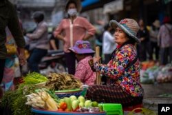 រូបឯកសារ៖ ស្ត្រីម្នាក់កំពុងលក់បន្លែនៅក្នុងផ្សារមួយ នៅរាជធានីភ្នំពេញ កាលពីថ្ងៃទី ១០ ខែវិច្ឆិកា ឆ្នាំ ២០២២។