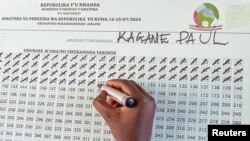 A worker from the National Electoral Commission (NEC) tallies casted ballots in favor of the Rwanda's incumbent President Paul Kagame at the G.S. Kagugu polling center in Kinyinya, Gasabo district of Kigali, July 15, 2024.