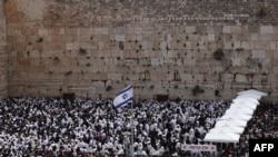 Jewish men take part in the Cohanim prayer (priest's blessing) during the Passover holiday at the Western Wall in the Old City of Jerusalem, Apr. 9, 2023.