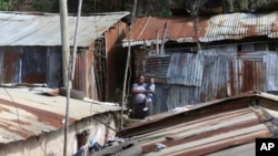 Jacinter Awino, 33, carries her son in the Kibera slum of Nairobi, Kenya, May 28, 2024.