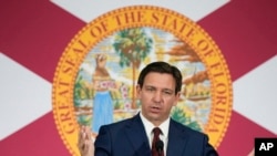 FILE - Florida Gov. Ron DeSantis at a news conference in Miami, May 9, 2023. A group of Chinese citizens living and working in Florida is suing the state over a new law that bans Chinese nationals from purchasing property in large swaths of the state.