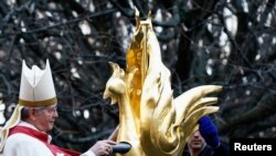 Archbishop of Paris Laurent Ulrich inserts the relics of Saint Denis, Saint Genevieve and the relics of the crown of thorns into the rooster, prior to its installation at the top of the spire of the Notre-Dame de Paris Cathedral, Dec. 16, 2023.