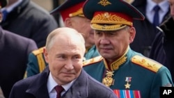 FILE - Russian President Vladimir Putin, left, and Russian Defense Minister Sergei Shoigu leave Red Square after the Victory Day military parade in Moscow, Russia, May 9, 2024. In a Cabinet shake-up, Putin replaced Shoigu as defense chief on May 12.