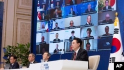 South Korean President Yoon Suk Yeol, right, speaks during the virtual AI Seoul Summit at the Blue House in Seoul, South Korea, May 21, 2024. (South Korea Presidential Office via AP)