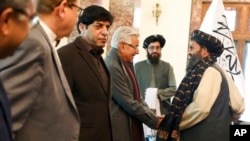 FILE - Pakistani Defense Minister Khawaja Asif shakes hands with Mullah Abdul Ghani Baradar, the Taliban-appointed deputy prime minister for economic affairs, during a meeting in Kabul, Afghanistan, on Feb. 22, 2023.