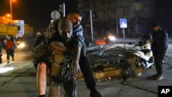 A soldier carries a man injured in the latest earthquake in Hatay, Turkey, Feb. 20, 2023. 