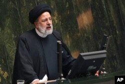 FILE - Iranian President Ebrahim Raisi addresses lawmakers at the parliament in Tehran, Iran, Jan. 22, 2023.
