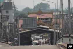People gather at a checkpoint near the 1st Thai-Myanmar Friendship Bridge in Myawaddy district in eastern Myanmar, April 12, 2024.