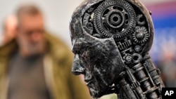 FILE - A metal head made of motor parts symbolizing artificial intelligence is seen in Essen, Germany, Nov. 29, 2019. Efforts to come up with rules to ensure AI's trustworthiness come as governments explore the impact of the technology.