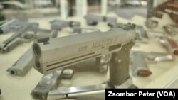 Handguns are displayed in a shop window in central Bangkok.