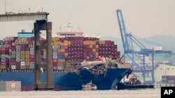 Tugboats escort the cargo ship Dali after it was refloated in Baltimore, May 20, 2024. The vessel struck the Francis Scott Key Bridge on March 26 causing it to collapse and resulting in the death of six people.