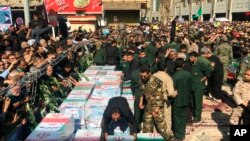 FILE - Caskets of those who died in a terror attack on a military parade in Iran are displayed in Ahvaz, Iran, Sept. 24, 2018. Iran hanged a man who was allegedly behind the attack, May 6, 2023.