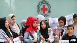 FILE - Palestinians gather for a vigil outside the offices of the International Committee of the Red Cross in Beirut on October 11, 2023, in support of the Palestinians in Gaza.