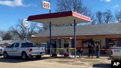 Law enforcement personnel work at the scene of a shooting, Feb. 17, 2023, in Arkabutla, Missippi. Six people were fatally shot in the small town; authorities said they had taken a suspect into custody.