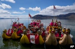Aymara Indigenous women arrive in boats on Lake Titicaca from the Uros floating islands to attend a march marking International Women's Day in to Puno, Peru, March 8, 2023.