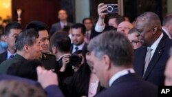 US Defense Secretary Lloyd Austin III, right, shake hands with China Defense Minister Li Shangfu, left, at the 20th International Institute for Strategic Studies Shangri-La Dialogue, Asia's annual defense and security forum, in Singapore, June 2, 2023.
