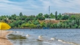 FILE - Strilka beach on the Inhul River in Mykolaiv, Ukraine. City beach near shallow water and the inscription Mykolaiv on the shore on July 26, 2020 (Adobe stock photo)