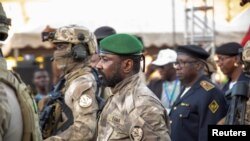 Mali's junta leader Assimi Goita arrives to attend the last campaign rally of the "Yes" group for the referendum on constitutional amendments that would return the country to constitutional rule, in Bamako, June 16, 2023. 