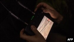 A Ukrainian drone operator of the 65th Mechanized Brigade tries to locate Russian army positions, near the front-line village of Robotyne in the Zaporizhzhia region, Oct. 1, 2023, amid Russia's war on Ukraine.