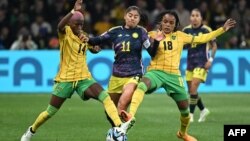 Colombia's forward #11 Catalina Usme fights for the ball with Jamaica's defender #14 Deneisha Blackwood and midfielder #18 Trudi Carter during the Women's World Cup football match between Jamaica and Colombia in Melbourne, Australia, Aug. 8, 2023. 