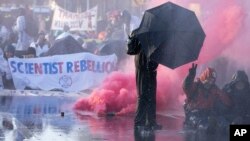 Police use a water cannon during a protest and blockade of a major highway in the downtown area near where it runs past the temporary home of the Dutch parliament, during a climate protest in The Hague, Netherlands, March 11, 2023.