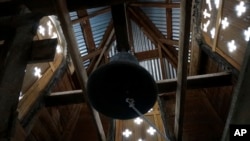 Sunlight shines through the belltower of the Holy Rosary Mission Church in Truchas, New Mexico, April 16, 2023. The church, built of adobe in the 1760s in this ridgetop village, hosts celebrations only a few times a year, but volunteers preserve it. 