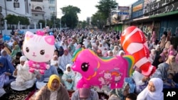 Muslim women attend an Eid al-Fitr prayer marking the end of the holy fasting month of Ramadan in Jakarta, Indonesia, April 10, 2024.