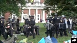 Police take down tents and detain protesters at the University of Virginia on May 4, 2024, in Charlottesville, Va. 