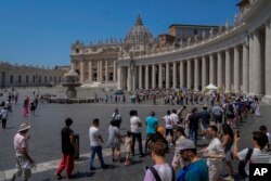 Wisatawan dan para peziarah mengunjungi Lapangan Santo Petrus di Vatikan, Senin, 10 Juli 2023. (AP Photo/Gregorio Borgia)