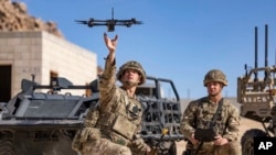 FILE - In this photo from the Defense Visual Information Distribution Service, British soldiers launch a drone during Project Convergence exercises at Fort Irwin, Calif., on Nov. 4, 2022. (DVIDS via AP)