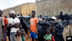 Migrants stuck in Niamey, Niger, stand in their makeshift camp Aug. 22, 2023. Some 7,000 migrants are stranded in Niger unable to go home after a coup last month where members of the presidential guard overthrew the country's democratically elected leader.
