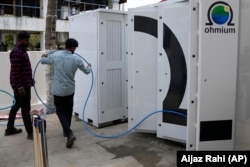 Technicians conduct tests on the electrolyzer hydrogen module at the Ohmium manufacturing facility in Chikkaballapur, outside Bengaluru, India, Tuesday, April 25, 2023. (AP Photo/Aijaz Rahi)