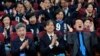 Cho Kuk, center, leader of the South Korean Rebuilding Korea Party, and his party members react as they watch a local media's results of exit polls for parliamentary election on television at the National Assembly in Seoul, South Korea, April 10, 2024.