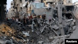 Palestinezët shohin dëmet pas goditjeve izraelite, pas sulmeve të befasishme të Hamasit. Gaza, 9 tetor 2023.