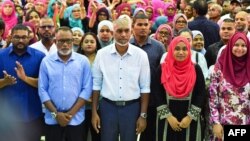 Maldives President-elect Mohamed Muizzu, center, of the People's National Congress (PNC) party delivers a speech during a gathering with supporters following the country's presidential election, in Male on Oct. 2, 2023.