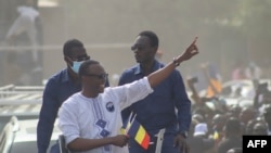 FILE - Success Masra, center, gestures as he arrives for a meeting of the Chadian political party Succes Masra (C) gestures as he arrives for a meeting of the Chadian political party The Transformers, in N'Djamena, March 10, 2024.