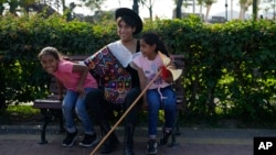 Peruvian musician Lenin Tamayo jokes with young fans while taking a break from recording a video in Lima, Peru, Aug. 3, 2023.