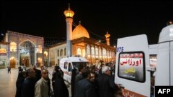 Emergency personnel transport the injured following a shooting attack at Iran's Shah Cheragh mausoleum in the Fars province capital Shiraz, on Aug. 13, 2023. 
