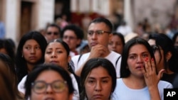 A woman wipes away tears during a demonstration protesting the kidnapping and killing of an 8-year-old girl, in the main square of Taxco, Mexico, March 28, 2024. 