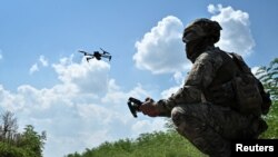 A Ukrainian serviceman of 108th separate territorial defense brigade launches a drone near a front line, amid Russia's attack on Ukraine, in Zaporizhzhia region, Ukraine, August 4, 2023. 