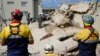 Rescue effort for dozens missing in South Africa building collapse are boosted by 1 more survivor 