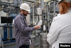 Air Company co-founder and chief technology officer Stafford Sheehan demonstrates the firm's patented system for converting carbon dioxide and hydrogen gas. (Air Company/Handout via REUTERS)
