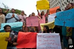 Members of Christian groups and others demonstrate to condemn the attack on a Christian area and a burned church by angry Muslim mob in Karachi, Pakistan, Aug. 16, 2023.
