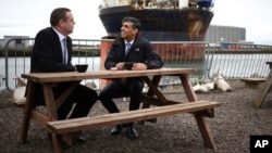 British Prime Minister Rishi Sunak speaks to Scottish Conservatives leader Douglas Ross, left, at the Port of Nigg, ahead of a campaign event in the buildup to the UK general election on July 4, in northeast Scotland, May 23, 2024.