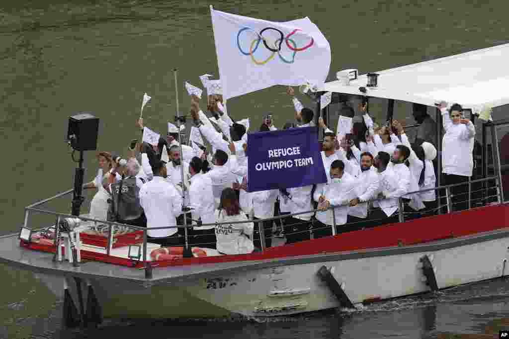 Members of the Refugee Olympic Team participate in the opening ceremony of the 2024 Summer Olympics in Paris, July 26, 2024.
