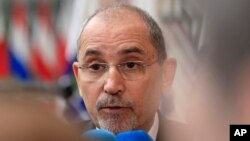 FILE - Jordan's Minister of Foreign Affairs Ayman Safadi speaks with the media as he arrives for a meeting at the European Council building in Brussels, May 27, 2024. 